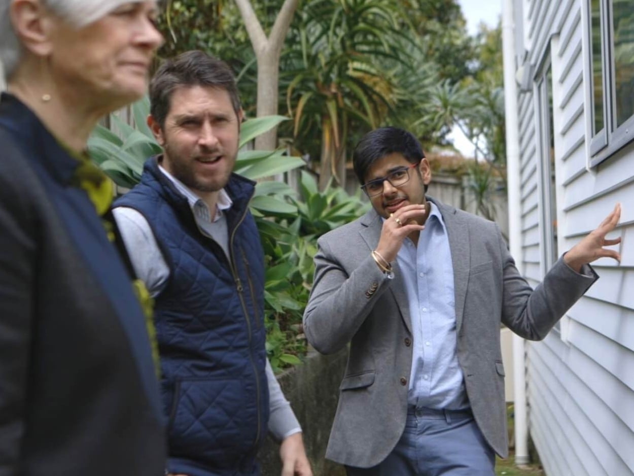 Angel staff with a client reviewing a home