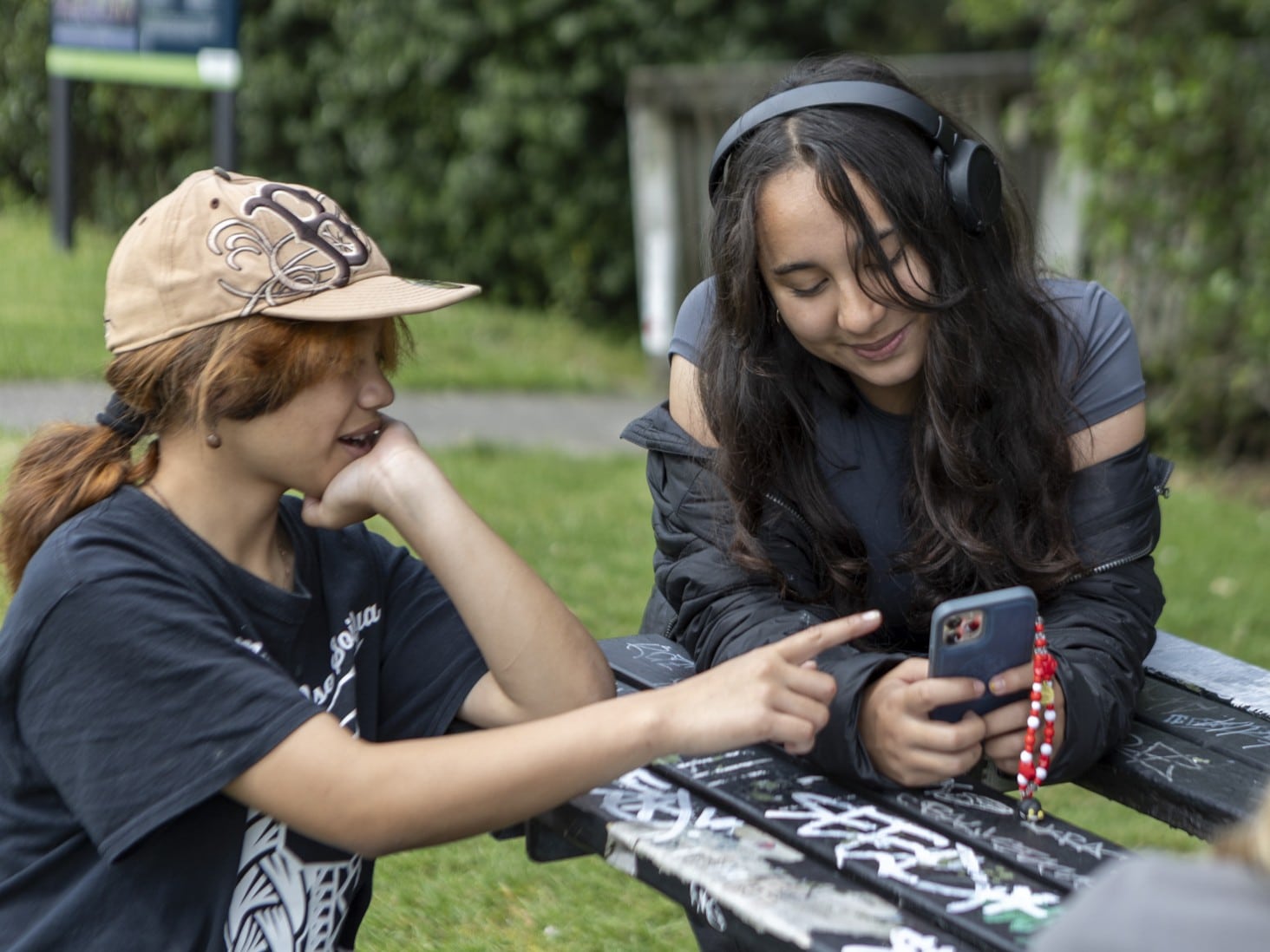 University of Auckland Students looking at a phone together